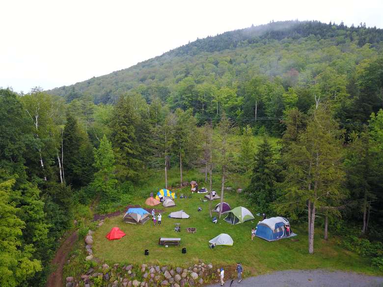 an aerial view of a campsite with multiple tents and campers