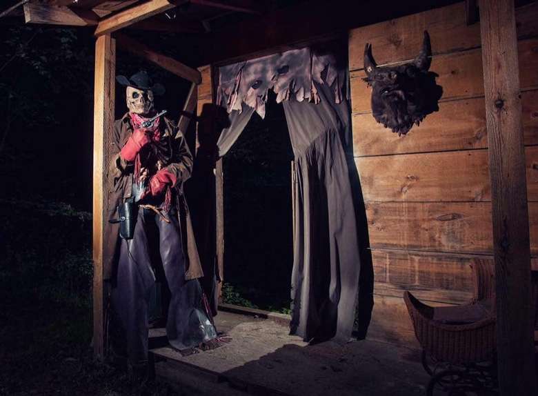 skeleton cowboy standing in a doorway