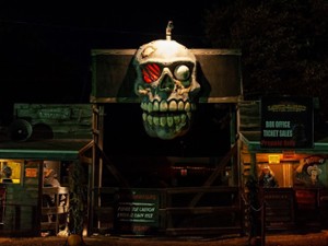 skull decor at the entrance of a haunted hayride gate