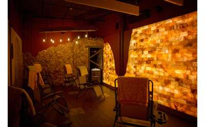 a man-made salt cave with lounge chairs and warm lighting