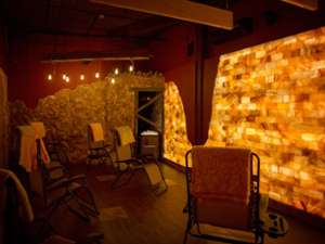 a man-made salt cave with lounge chairs and warm lighting