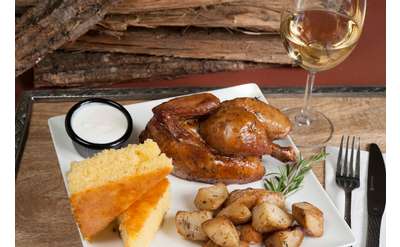 a whole chicken dinner with cornbread and potatoes