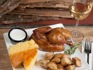 a whole chicken dinner with cornbread and potatoes