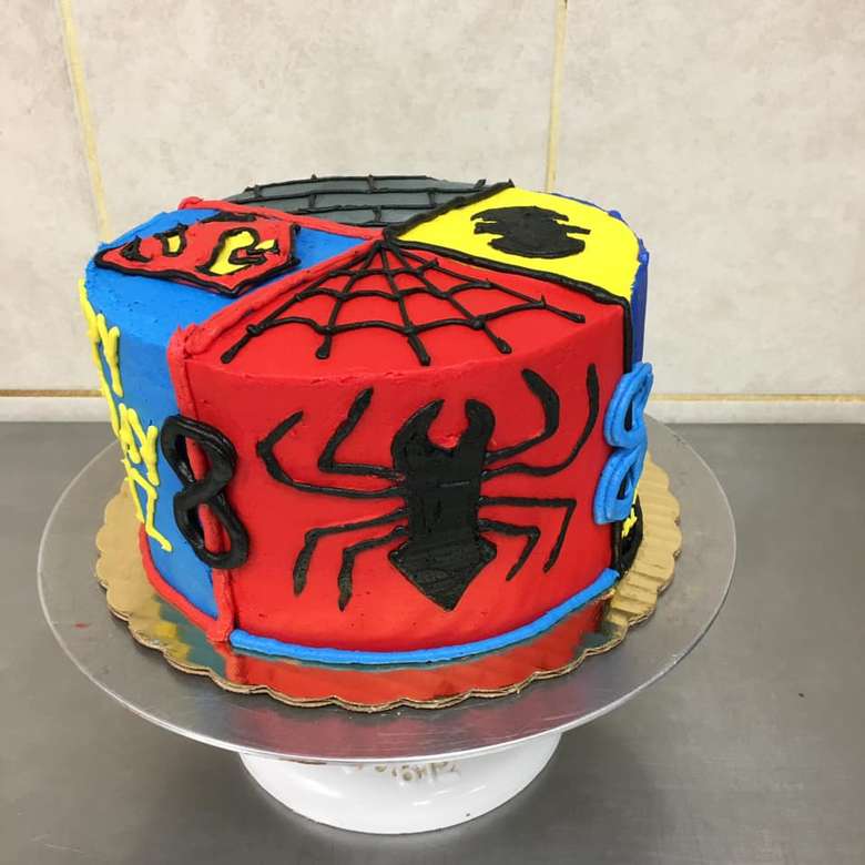 a cake with superhero frosting design