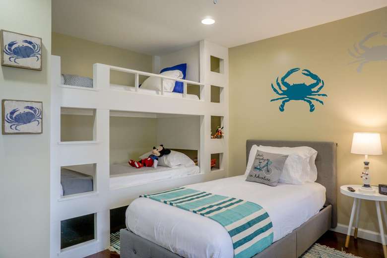 a bedroom with a twin bed bunk beds, and crab images on the walls
