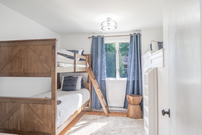 Main Level Bunk room with twin bunk beds and one twin loft bed with wall ladder to access.  (3 twin beds total).
