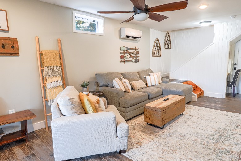 Lake Level Living Room with lake views and TV.  There are board games located in the trunk coffee table.  Also, in this space is a workstation with a desk and chair.