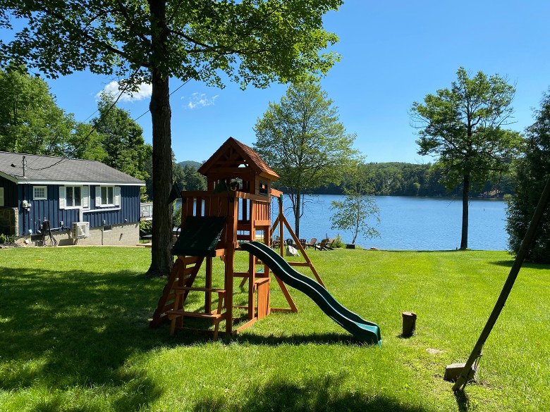 Play set with swing and slide on the side yard.