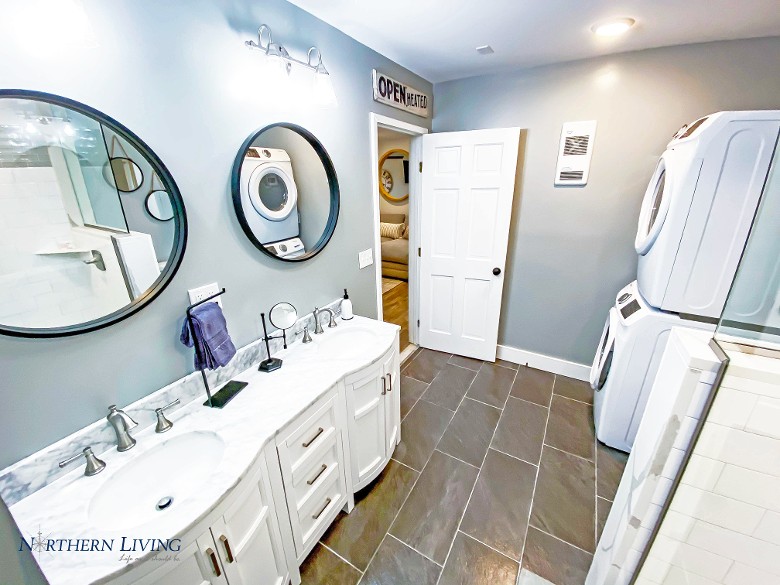 Downstairs bathroom with 2 sinks, and shower.  Also, a washer and dryer.