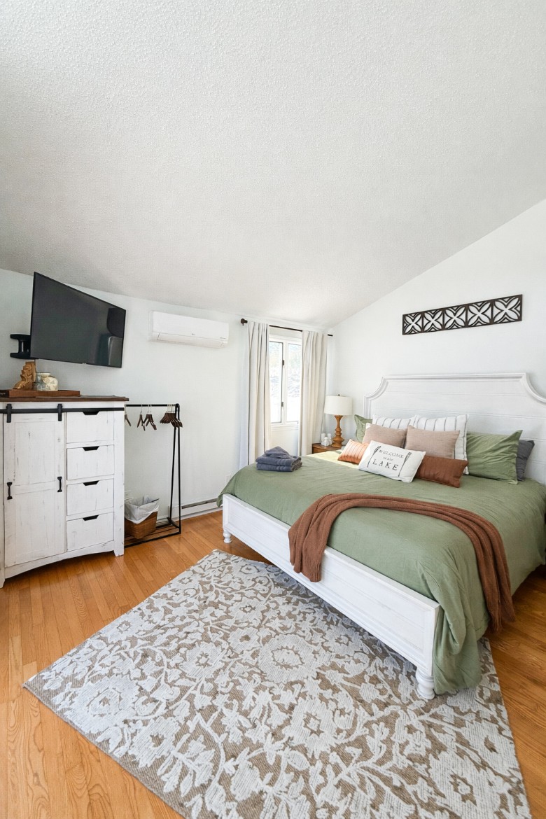 Main Level King Bedroom.  Walk out onto the deck with a private entrance with stunning Lake Views.