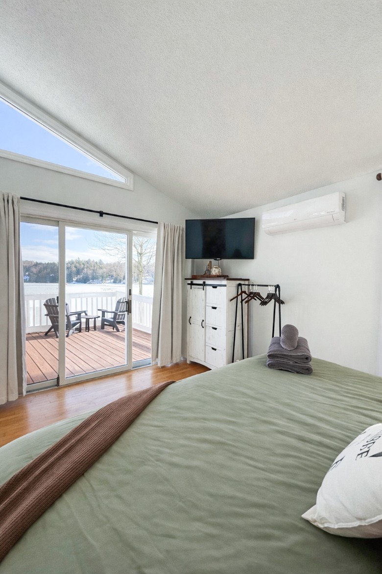 Main Level King Bedroom.  Walk out onto the deck with a private entrance with stunning Lake Views.