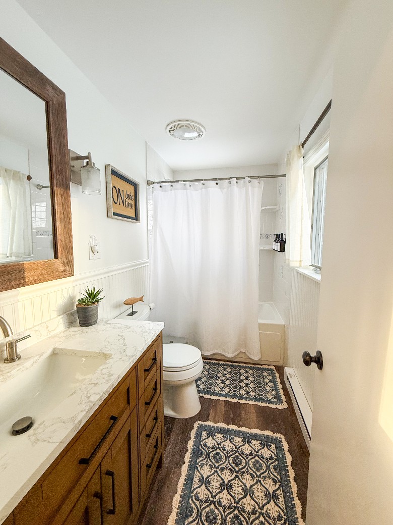 Main Level ~ Full bathroom with tub and shower.
