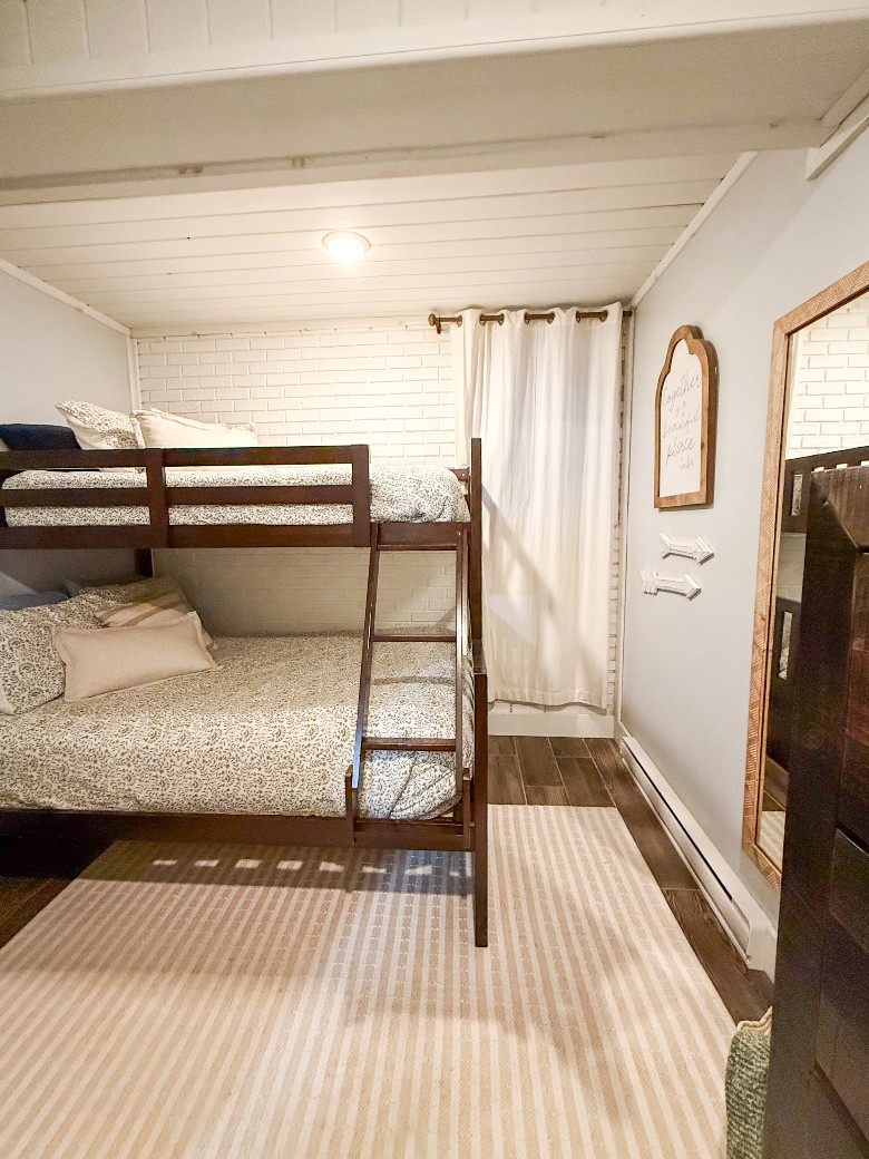 The lower-level Bunk Bedroom has a full bunk on the bottom and a twin on top. There is also a chest of drawers for clothing storage.