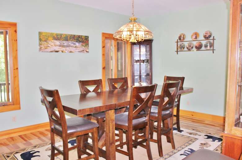 a dinner table with chairs around it
