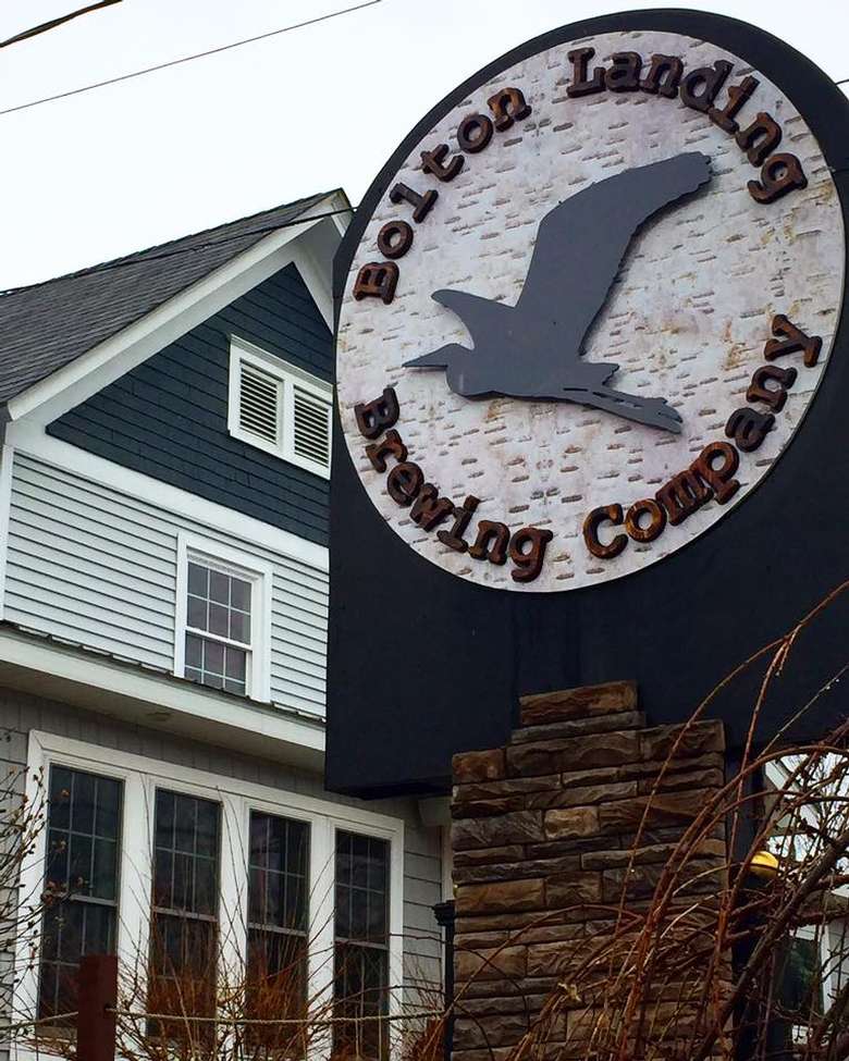 the sign for bolton landing brewing company in front of a building