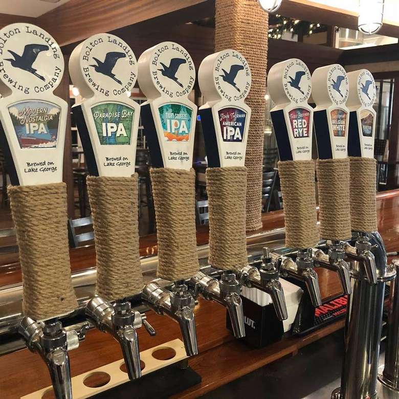 seven taps lined up at a bar