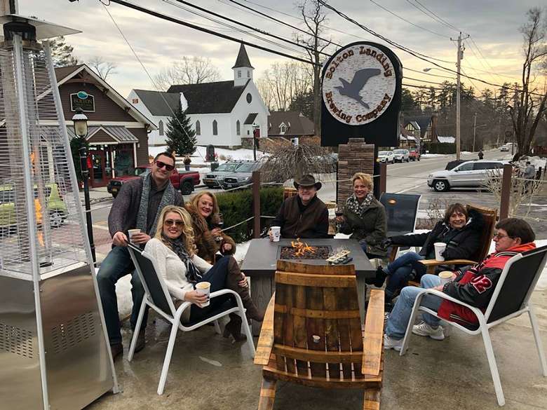 people seated at the outdoor patio area at a brewing company
