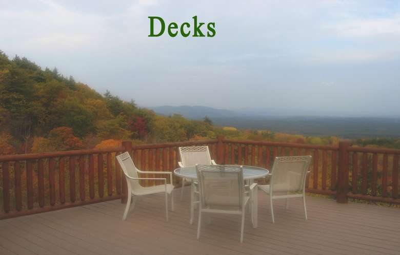 patio chairs and table on a deck overlooking a landscape