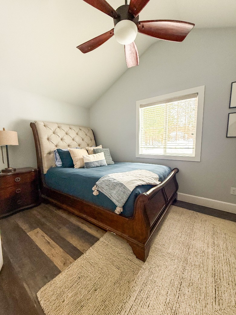 Main level queen bedroom, located near the dining area and main level bathroom.