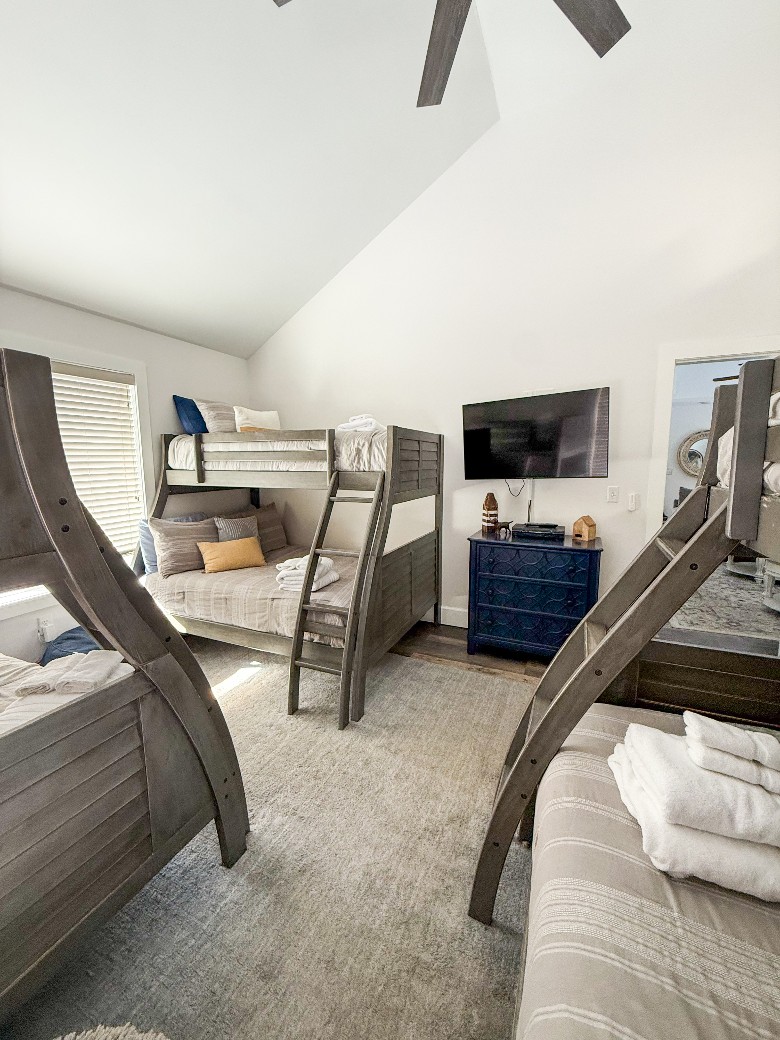 Upstairs bedroom with 3 sets of bunkbeds each with a twin over full