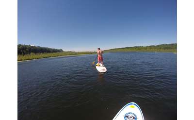 a person in the distance stand up paddle boarding