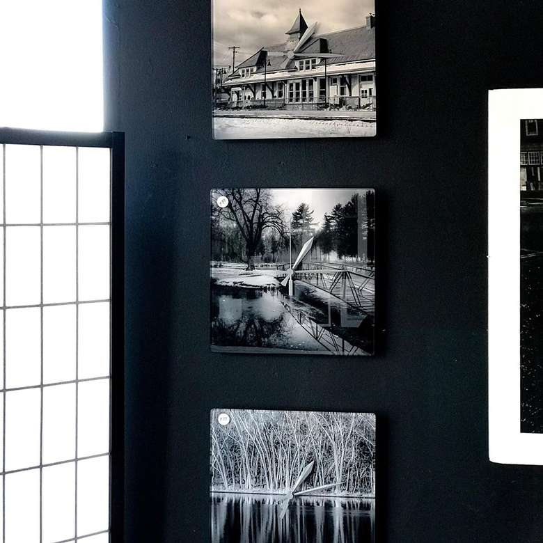 a few artworks hanging from a wall