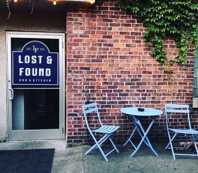 the entrance of a brick building with sign on the door