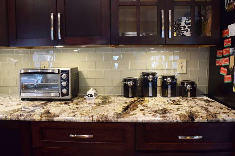 stone kitchen countertop with microwave oven and canisters