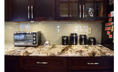 stone kitchen countertop with microwave oven and canisters