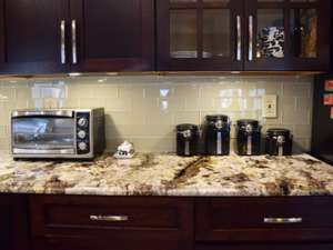 stone kitchen countertop with microwave oven and canisters