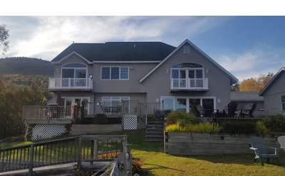 the exterior of a large house with decks