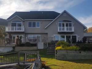 the exterior of a large house with decks