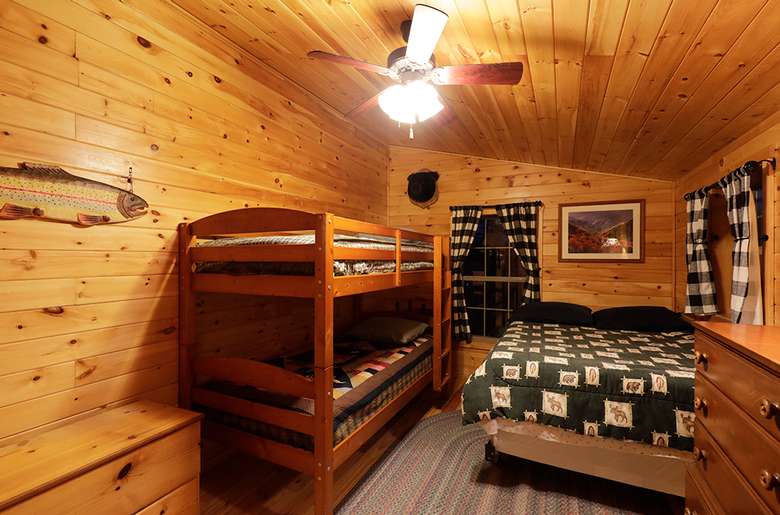 a bedroom with a bunk bed and a regular bed