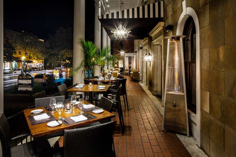 an outdoor patio dining area in the evening