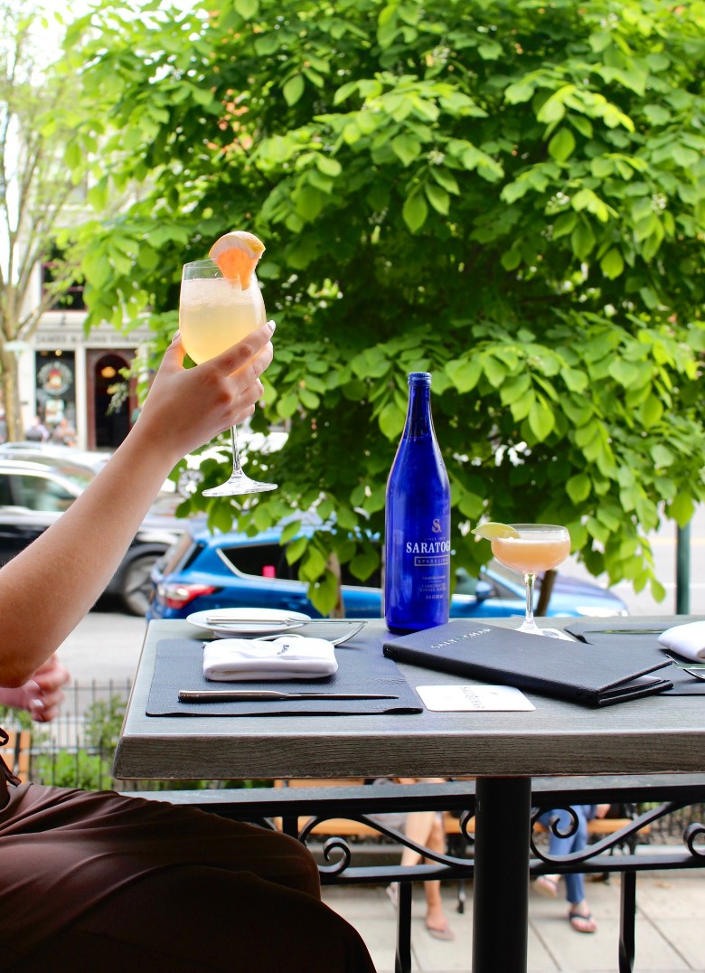 person seated on patio with drink