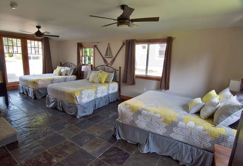 a large bedroom area with three beds