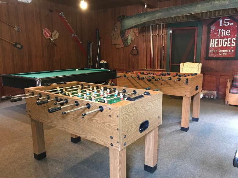 foosball and other game tables in a room