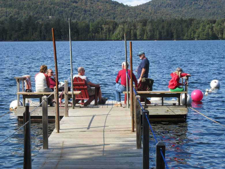 group of people on the end of a boat dock