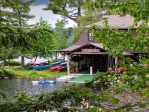 Main Lodge porch and boat dock face the lake