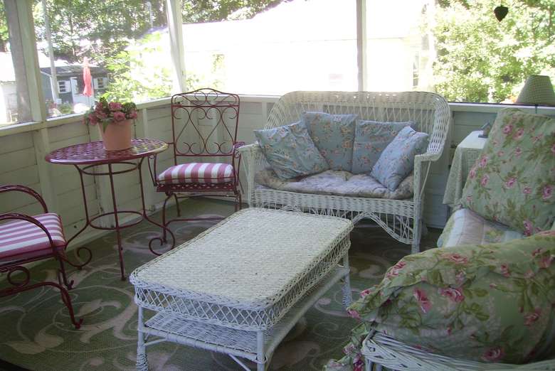 wicker furniture on screened-in porch
