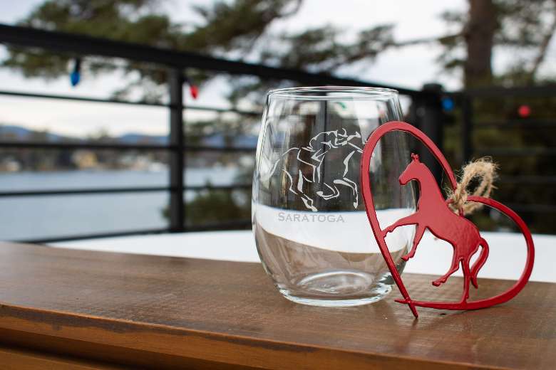 Saratoga stemless wine glass paired with a red horse ornament.