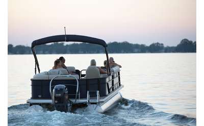 Family on a pontoon boat at sundown