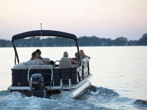 Family on a pontoon boat at sundown