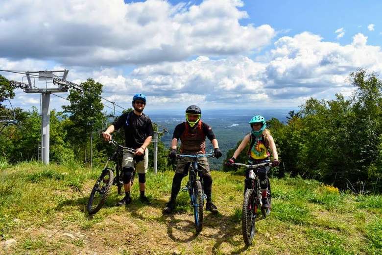 three mountain bikers on a trail