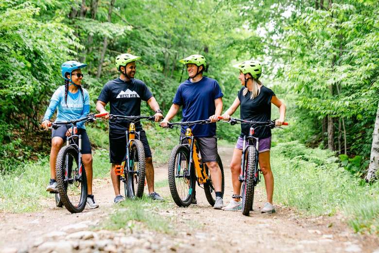two adults and two women on mountain bikes