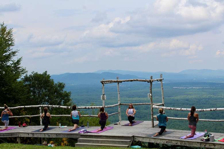 people doing mountaintop yoga