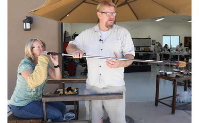 woman trying glassblowing