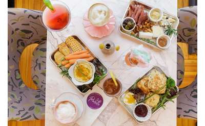 various dishes, drinks, and a palette cafe menu on a table