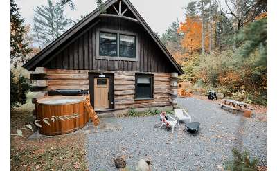log cabin with hot tub out front