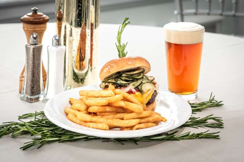 plate of burger and fries with a beer on the side
